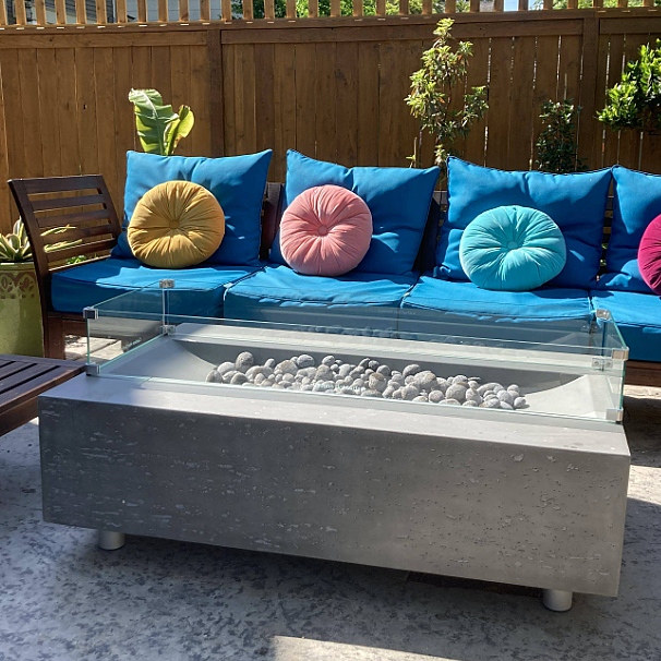Modern rectangular concrete fire pit with glass guard